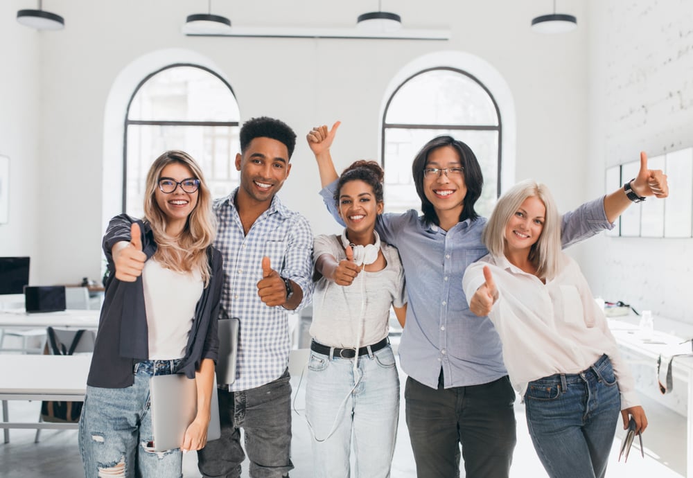 blonde-female-student-ripped-jeans-holding-laptop-laughing-after-hard-test-asian-guy-glasses-waving-hands-celebrating-end-exams-beginning-vacation 1
